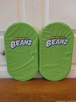 Front view of both green Mighty Beanz cases closed
