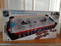 Front view of sealed NHL tabletop air hockey box
