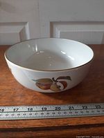 Side view showing fruit motif and scale