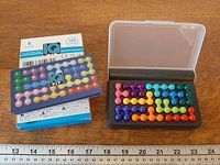 Closed and open IQ Fit case with pieces assembled, box back shown, ruler for scale