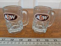 Both miniature A&W glass mugs front view with ruler for scale