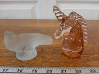 Overall view of Lalique sparrow and pink glass unicorn with scale