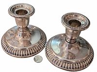 Both candlesticks side by side with coin for scale