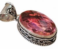 Front view showing oval pink stone and filigree bezel