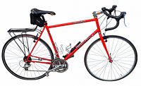 Full side view of red Brodie Romax Racing road bicycle with rack and accessories