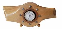 Front view of wooden propeller clock showing dial, propeller shape and feet