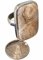 Front view showing banded agate cabochon and size comparison with coin