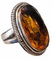 Side view showing beaded bezel and faceted stone