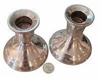 Pair of short sterling candlesticks with coin for scale