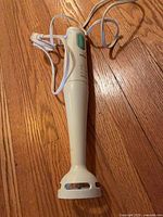 Full view of Braun stick blender showing handle, shaft, and cord