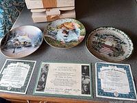 Three collector plates with certificates of authenticity and boxes
