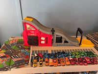 Overview of playset, mat and row of die-cast cars