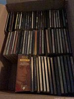 Box filled with rows of CD jewel cases and Mozart boxed set