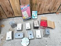 all items laid out: galvanized boxes, round cover, wire nuts box, sealed switches