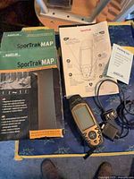GPS unit, box, manuals, cable and adapter laid out