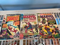 Front covers of all three comics on shelf