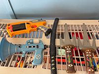 Full lot showing Nerf blaster, Minions blaster, katana with sheath, pair of sai