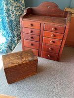 Cabinet front showing ten drawers and box beside it