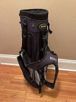 Full side view of RAM stand golf bag showing branding, pockets, and stand legs