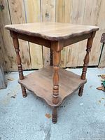 Full view showing both tiers, turned legs, scalloped edges, overall wear