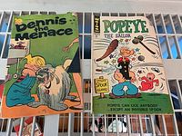 Both comic books side-by-side showing full front covers