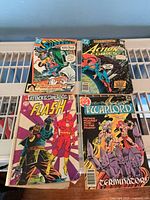 All four comics laid out to show full covers