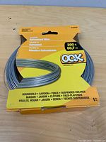 Front view of packaged OOK galvanized wire showing gauge and length