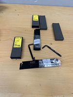 All contents laid out: two wrapped blades, four gray boxes, two hex keys