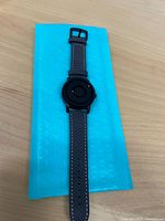 Top view of entire wristwatch on blue padded envelope