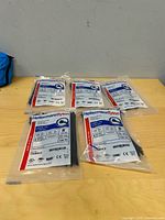 Five sealed packs of HellermannTyton cable ties on table