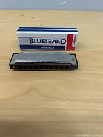 Hohner Bluesband harmonica and box front view
