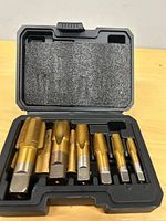 Overview of open case showing six gold-finish taps
