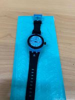 Front view of watch on blue bubble sleeve
