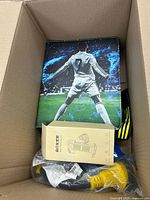 Box interior showing soccer graphic case, boxed accessory, pump head