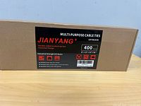 Front view of sealed JIANYANG cable tie box showing 400-piece count and size assortment