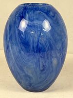 Full front view of blue swirled glass vase
