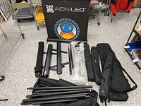 Group of banner stands, aluminum poles, carry bags; visible Aion LED graphic
