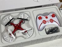 Tray showing quadcopter, controller and cable inside packaging
