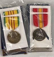 Vietnam Service and National Defense medal sets in sealed plastic