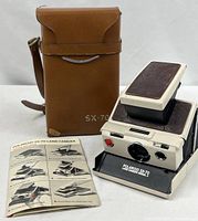 Camera, carrying case, and booklet together