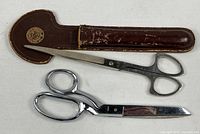 Both pairs of scissors and leather holder overview