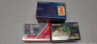 Three sealed cassette multipacks: Sony HF 90 five-pack, BASF Ferro Extra I 90 two tapes, GoldStar CRX 100 three-pack