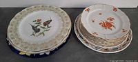 Two stacks of assorted plates showing patterns and sizes