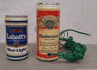Front view of both beer can telephones with cords visible