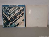 Front covers of 1967-1970 blue album and White Album