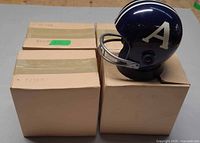 One helmet radio on display with three boxed units