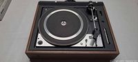 Top view of Dual 1226 turntable with tonearm, platter and wood plinth