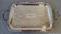 Top view showing entire silver plated tray, ornate etching, handles