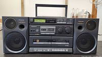 Front view showing entire Panasonic RX-DT680 boombox with speakers attached