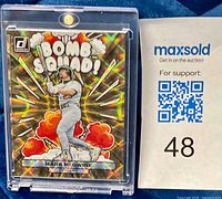 Front of 2023 Donruss Bomb Squad Mark McGwire card in protective case showing serial number 699/999